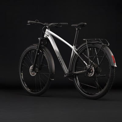Silbernes Cube Mountainbike mit Schutzblechen und Gepäckträger vor schwarzem Hintergrund. Silbernes Cube Mountainbike mit Schutzblechen und Gepäckträger vor schwarzem Hintergrund.