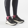 Schwarze Salomon Laufschuhe mit rosa Socken und weißer Sohle.