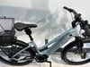 Hellblaues Specialized E-Bike mit Vorderradkorb und Federung.