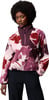 Frau mit Afro-Frisur in einem rosa Fleece-Pullover mit Blumenmuster.