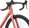 Ein rosafarbenes Scott Gravelbike mit schwarzem Lenker und Reifen.