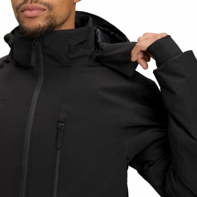 Ein Mann in einem schwarzen Mantel passt den Kragen einer Kapuzenjacke an. Ein Mann in einem schwarzen Mantel passt den Kragen einer Kapuzenjacke an.