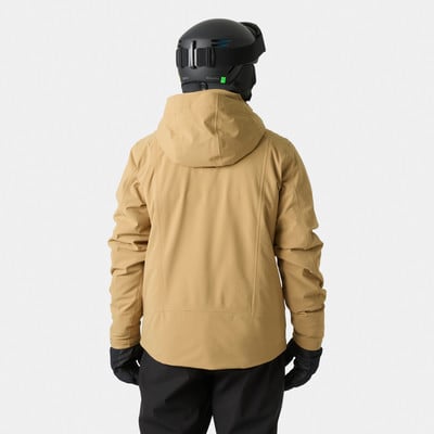 Rückansicht einer Person in einer beige Skijacke und schwarzem Helm. Rückansicht einer Person in einer beige Skijacke und schwarzem Helm.