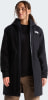 Eine Frau in einer schwarzen The North Face Jacke mit Kapuze und brauner Hose.
