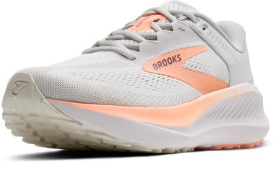 Grau-weiße Brooks Laufschuhe mit orangefarbenen Akzenten und Logo. Grau-weiße Brooks Laufschuhe mit orangefarbenen Akzenten und Logo.