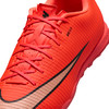 Nahaufnahme eines orangefarbenen Fußballschuhs mit Schnürsenkeln und Nike-Logo.
