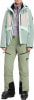 Damen-Skijacke und -hose in Pastellfarben mit Skischuhen.