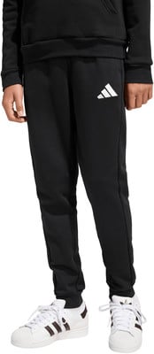 Schwarze Jogginghose mit weißem Adidas-Logo und weiße Sneaker mit braunen Streifen. Schwarze Jogginghose mit weißem Adidas-Logo und weiße Sneaker mit braunen Streifen.