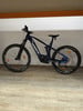 Dunkelblaues Haibike E-Bike mit Federung auf Holzboden.