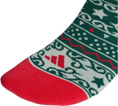 Rote Spitze und Weihnachtsbaum-Muster auf grünem Socken mit Adidas-Logo. Rote Spitze und Weihnachtsbaum-Muster auf grünem Socken mit Adidas-Logo.