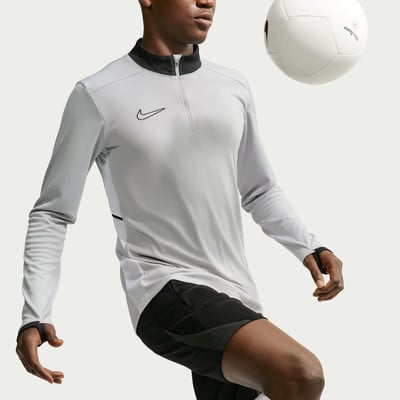 Fußballer im grauen Trikot mit Nike-Logo und schwarzem Kragen, Ball darüber.