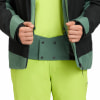 Detail einer Winterjacke und Hose mit Händen in den Taschen, grün und schwarz.