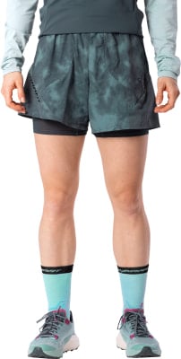 Frau in kurzen dunkelgrünen Shorts mit Print und hellblauen Socken. Frau in kurzen dunkelgrünen Shorts mit Print und hellblauen Socken.