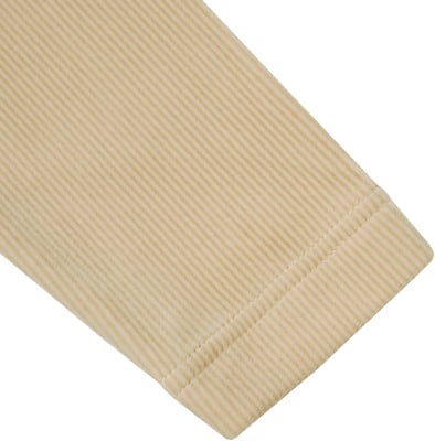 Beige Ärmelbündchen mit feinem Rippenmuster und zwei Nähten.