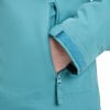 Geschlossene Reißverschlusstasche an einer türkisfarbenen Jacke mit verstellbarem Ärmel.