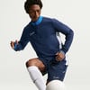 Mann in dunkelblauem Fußballtrikot mit weißem Nike-Logo und blauem Kragen.