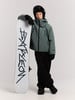 Ein Junge in Skijacke und Hose steht mit einem Snowboard.