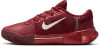 Dunkelroter Tennisschuh von Nike mit weißem Logo und Text auf der Ferse.