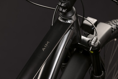 Rahmendetail eines schwarzen E-Bikes mit AIM-Logo und Gabel. Rahmendetail eines schwarzen E-Bikes mit AIM-Logo und Gabel.