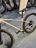 Ein silbernes Mountainbike mit schwarzem Sattel und schwarzen Pedalen auf blauem Untergrund.