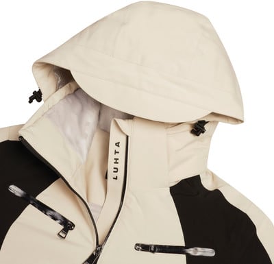 Beige Jacke mit Kapuze und schwarzen Einsätzen, Luhta-Logo am Kragen. Beige Jacke mit Kapuze und schwarzen Einsätzen, Luhta-Logo am Kragen.
