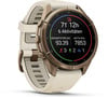 Eine goldene Garmin Smartwatch mit beigem Armband und einem übersichtlichen Zifferblatt.