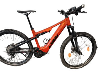 Orange KTM Mountain E-Bike mit Federung und Scheibenbremsen.