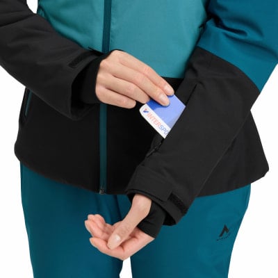 Hand steckt Karte in Ärmeltasche einer Skijacke.