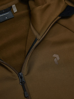 Detail einer Jacke mit dem Peak Performance Logo und Reißverschluss. Detail einer Jacke mit dem Peak Performance Logo und Reißverschluss.