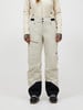 Damen-Skihose in Beige mit schwarzem Saum und Skischuhen.