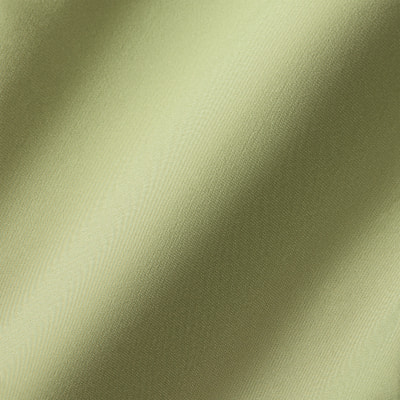 Hellgrüner Stoff mit feiner Textur und Falten. Hellgrüner Stoff mit feiner Textur und Falten.