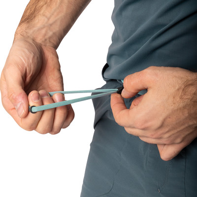 Ein Mann passt den Kordelzug an seiner Hose an. Ein Mann passt den Kordelzug an seiner Hose an.