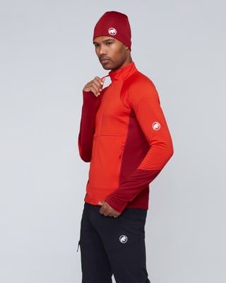 Mann in roter Jacke und Mütze mit Mammut-Logo. Mann in roter Jacke und Mütze mit Mammut-Logo.