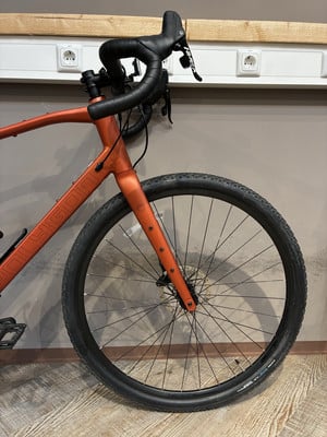 Orange Gravelbike mit schwarzem Lenker und Vorderrad. Orange Gravelbike mit schwarzem Lenker und Vorderrad.