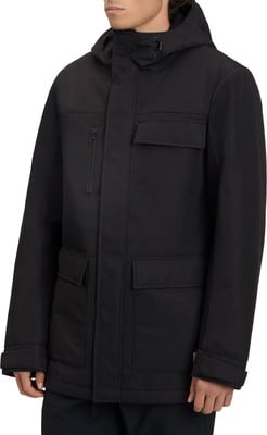 Ein Mann in einem schwarzen Wintermantel mit Kapuze und Taschen. Ein Mann in einem schwarzen Wintermantel mit Kapuze und Taschen.