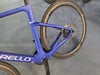 Blauer Rennradrahmen mit schwarzen Rädern und Pinarello-Logo.