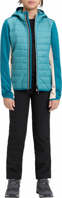 Mädchen in einer gesteppten Kapuzenjacke, schwarzer Hose und Turnschuhen. Mädchen in einer gesteppten Kapuzenjacke, schwarzer Hose und Turnschuhen.