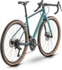 Ein grünes Gravelbike mit braunen Reifen und Scheibenbremsen.