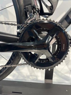 Detail des Kettenblatts und der Kette an einem schwarzen Fahrrad von Shimano. Detail des Kettenblatts und der Kette an einem schwarzen Fahrrad von Shimano.