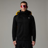 Ein Mann in schwarzer Kleidung mit gelbem Rucksack und Sonnenbrille.