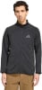 Mann in schwarzer Jacke mit Adidas-Logo und brauner Hose.