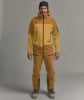 Ein Mann in Skibekleidung mit einer Jacke und Hose in Brauntönen.