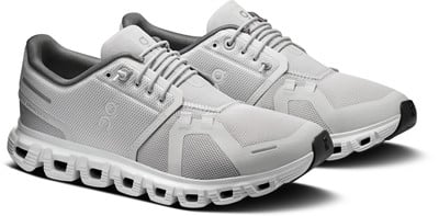 Graue Laufschuhe mit weißer Sohle und schwarzen Akzenten an der Spitze.