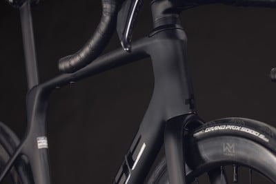 Detailaufnahme des schwarzen Carbonrahmens eines Rennrads mit Lenker. Detailaufnahme des schwarzen Carbonrahmens eines Rennrads mit Lenker.