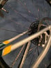 Detail eines Fahrrad-Hinterrads mit Kette und Bremsscheibe.