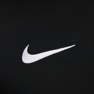 Weißes Nike-Logo auf schwarzem Textil, Nahaufnahme.