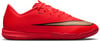 Červená futbalová obuv so zlatým dizajnom Nike Swoosh.