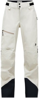 Eine beige Skihose mit schwarzen Akzenten und einem kontrastierenden Saum. Eine beige Skihose mit schwarzen Akzenten und einem kontrastierenden Saum.