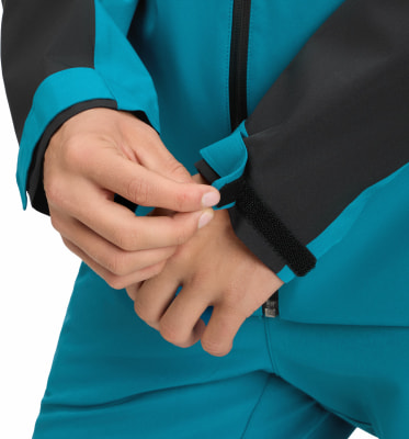 Detail einer Hand, die einen Klettverschluss am Ärmel einer Jacke anpasst. Detail einer Hand, die einen Klettverschluss am Ärmel einer Jacke anpasst.