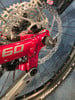 Das Hinterteil eines roten Mountainbikes mit Scheibenbremse und der Aufschrift 60.